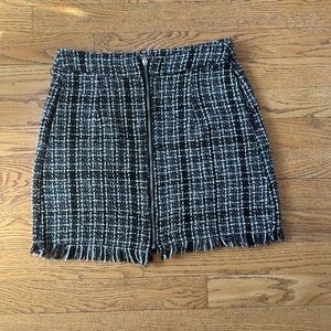 Black and white zippered mini skirt with frayed hem